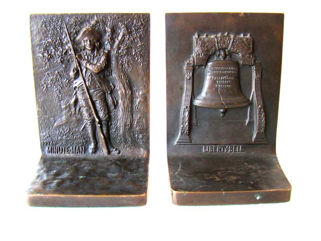 A Beautiful pair of Solid Bronze Antique Bookends circa 1915 depicting the Liberty Bell and the Minuteman of 1774.